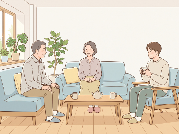 リビングで息子と3人でお茶を飲みながら話をする50代カップル